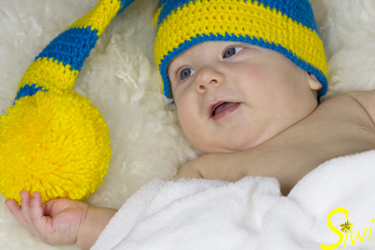 Jannis, 3 Monate jung, mit großer Bommelmütze